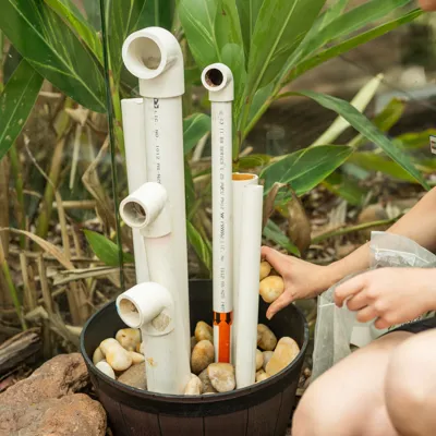 Keeper Leia Cook Secures PVC Piping (Rooms) For The Frog Hotel WILD LIFE Sydney Zoo